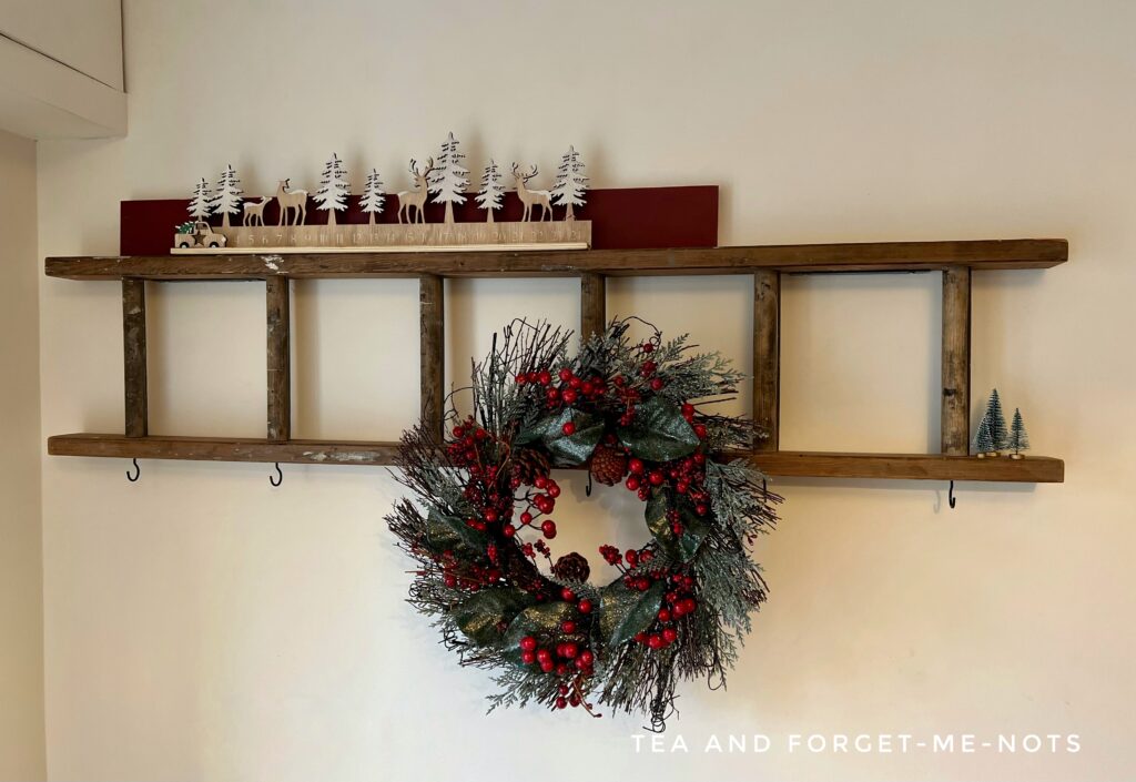 ladder decorated with a wreath for christmas