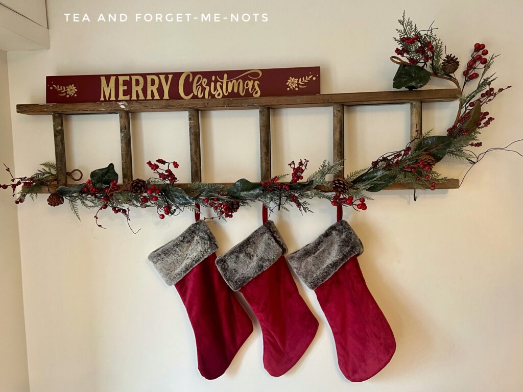 ladder decorated with stockings for christmas