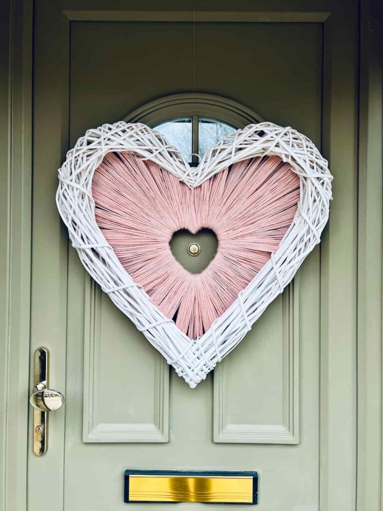 image shows valentine's yarn wreath on front door.