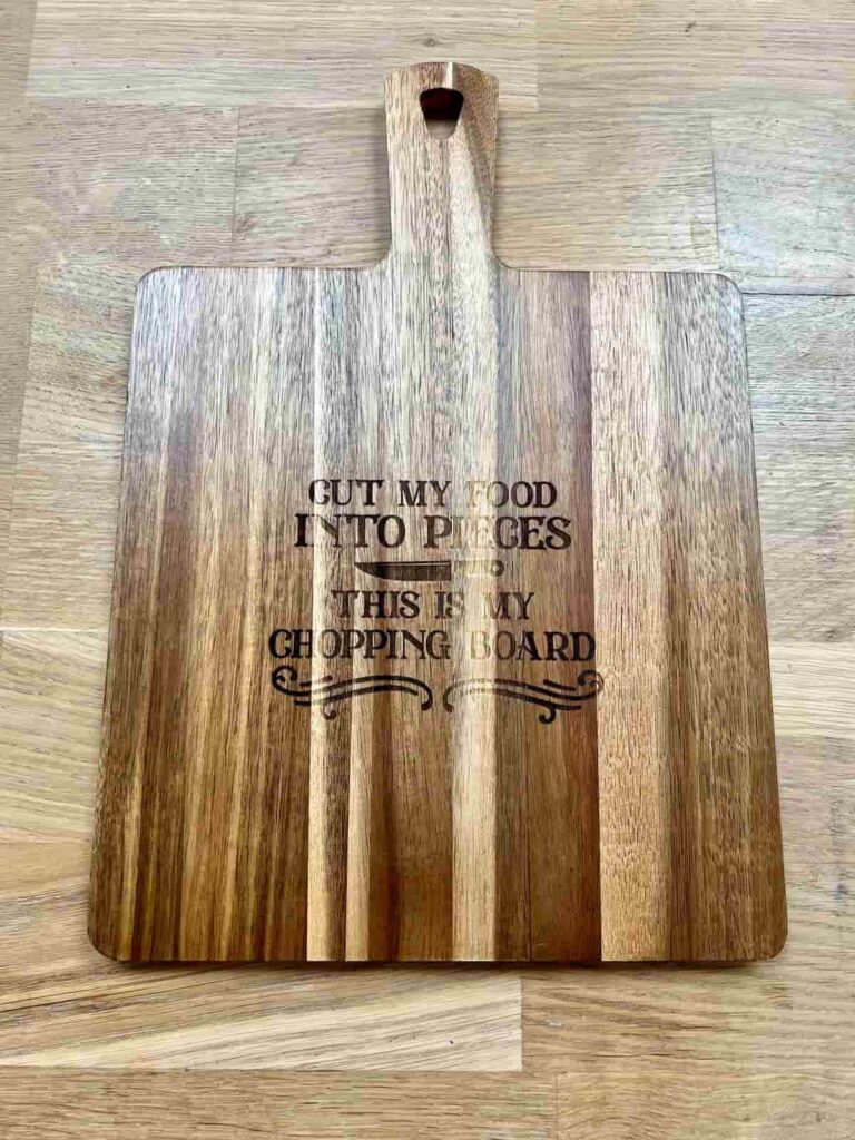 image shows laser engraved chopping board with song lyrics.