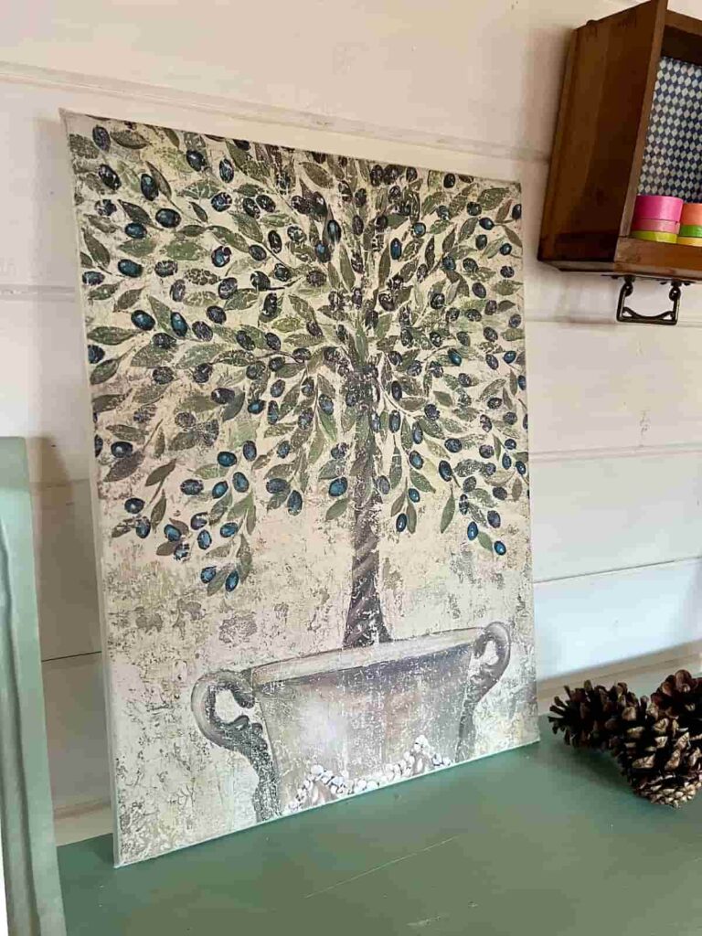 image shows potted tree decoupaged onto canvas leaning against wall.