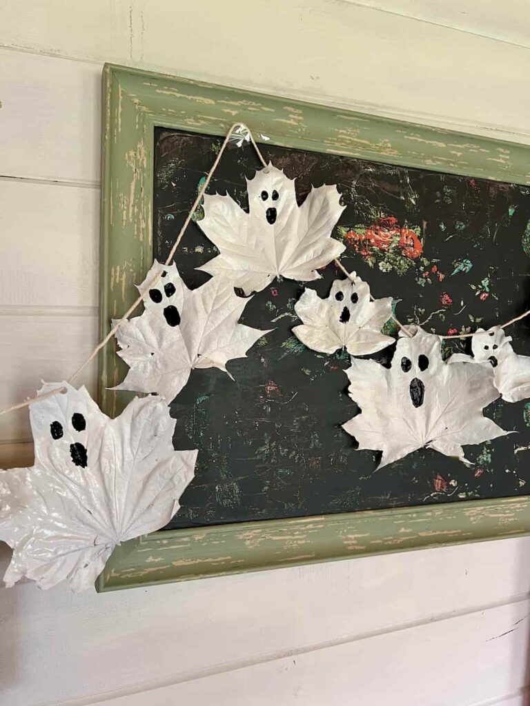 image shows leaves painted white as ghosts on a pinboard.