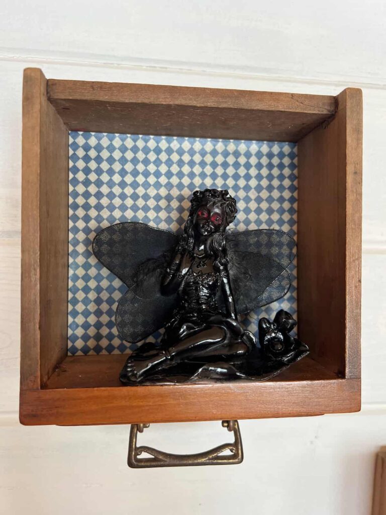 image shows painted figurine in a box.