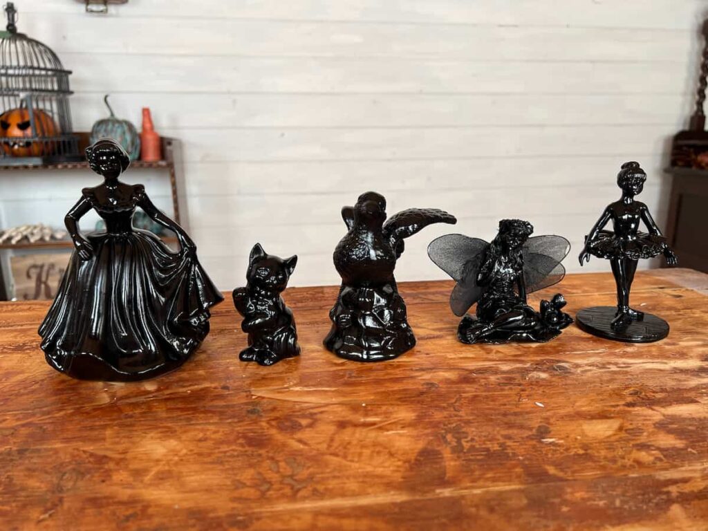 image shows ceramic figurines painted black.