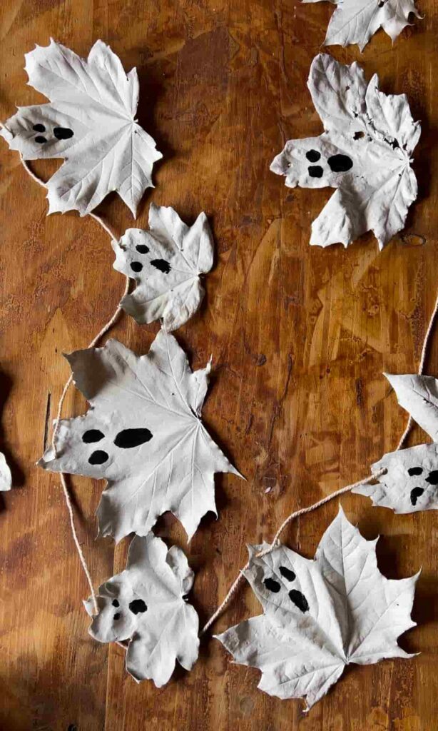 image shows threading leaf ghosts onto garland.