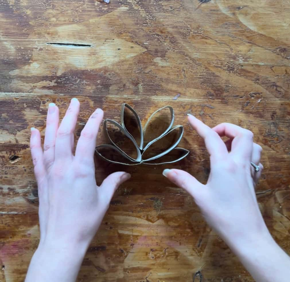 image shows 6 pieces of gold toilet paper roll glued together in fan shape.