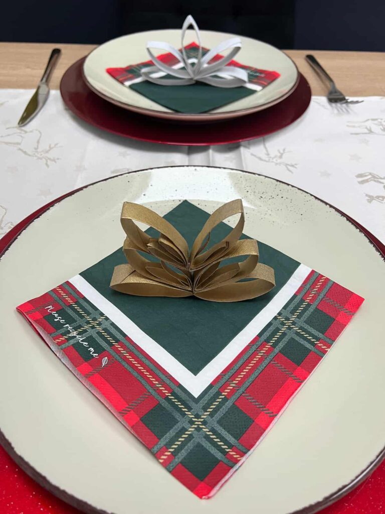 image shows table setting with tartan napkin and napkin holder.