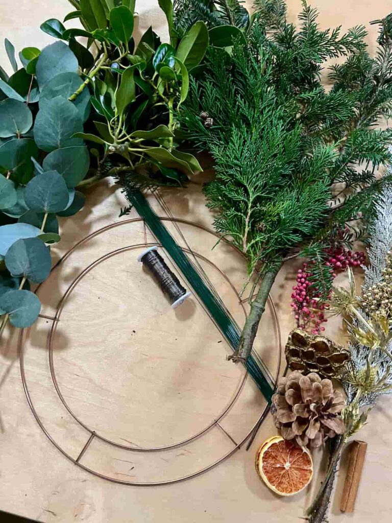 image shows metal hoop wreath, wire and greenery.