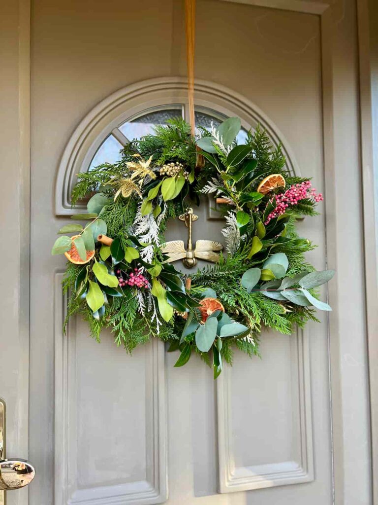 image shows christmas wreath on front door.