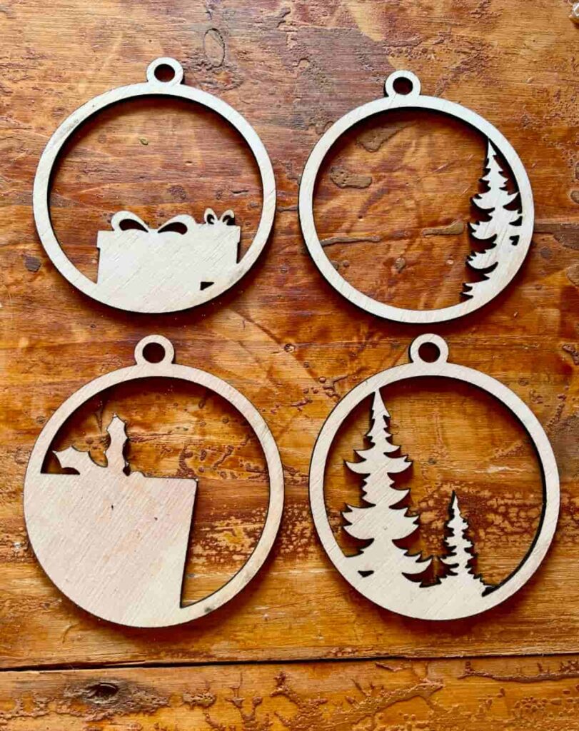 image shows two laser cut ornaments after cutting.