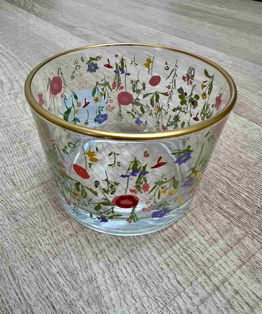 image shows glass container with flower pattern.