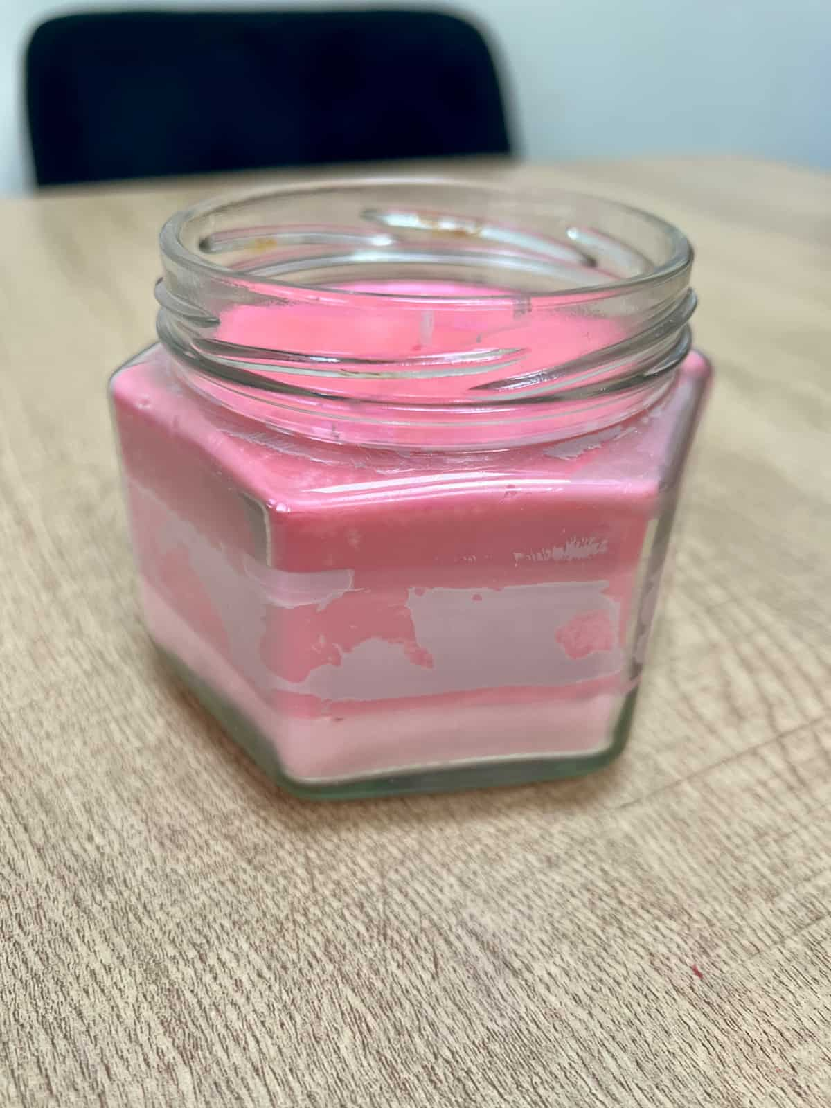 image shows frosting on pink wax candle.