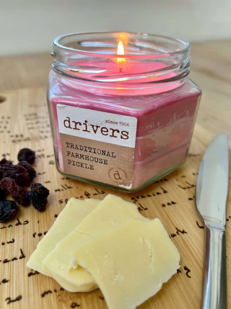 image shows pink layered candle with cheese on a cutting board.