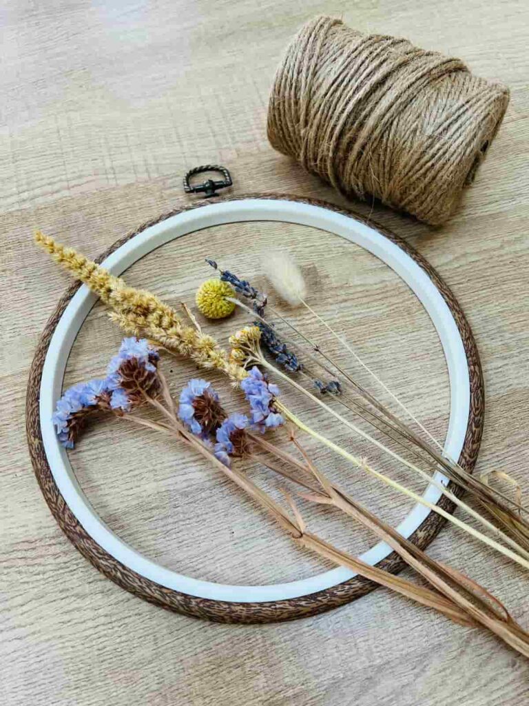 image shows string, embroidery hoop and dried flowers.