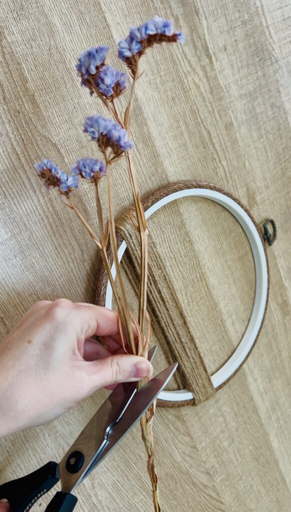 image shows cutting stem of dried flower.