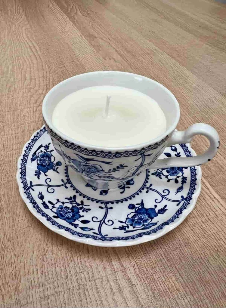 image shows soy wax candle in a tea cup.