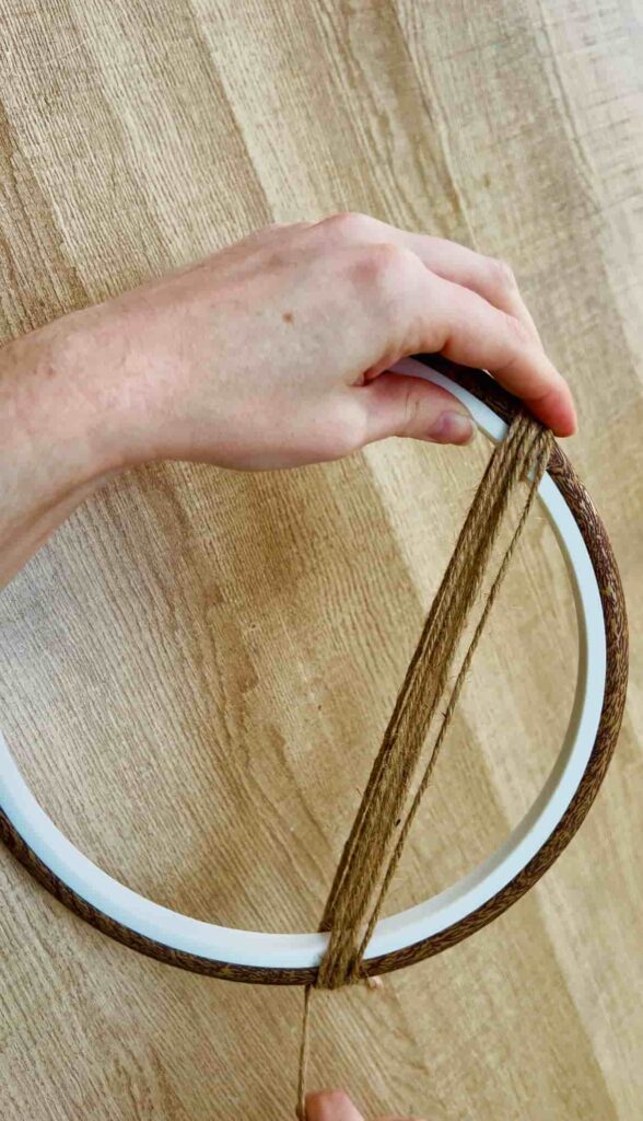 image shows string wound round embroidery hoop.