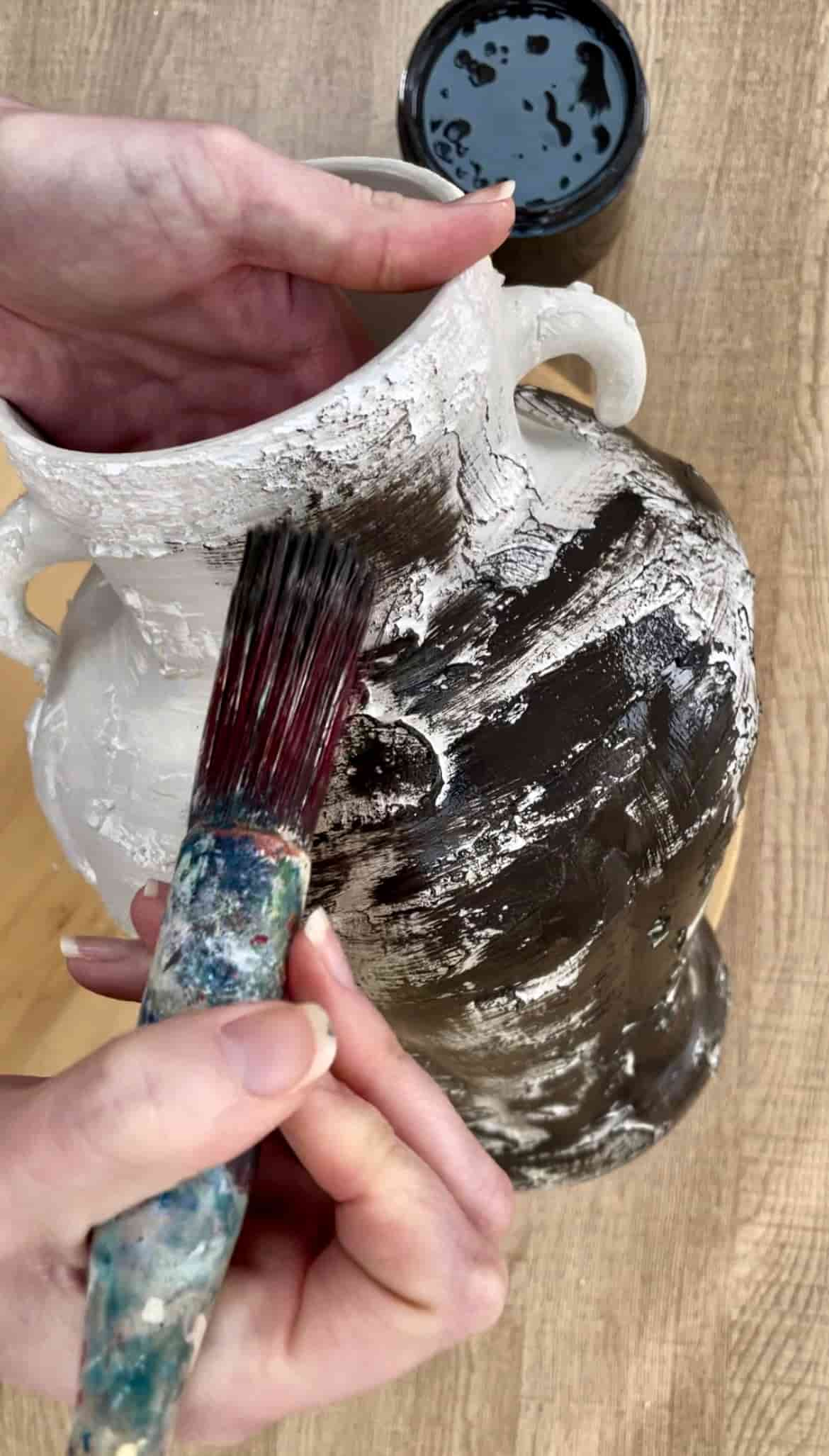 image shows painting vase with brown paint.