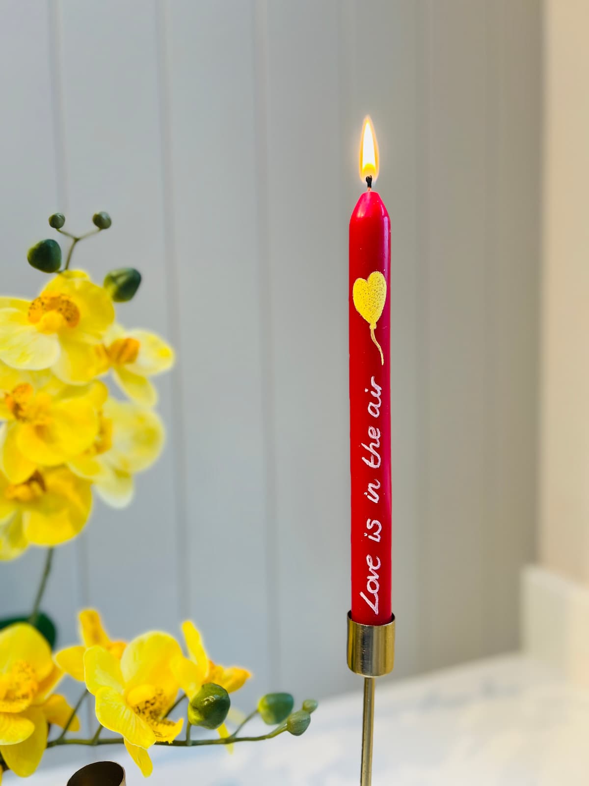 image shows valentines candle with writing and heart balloon painted.