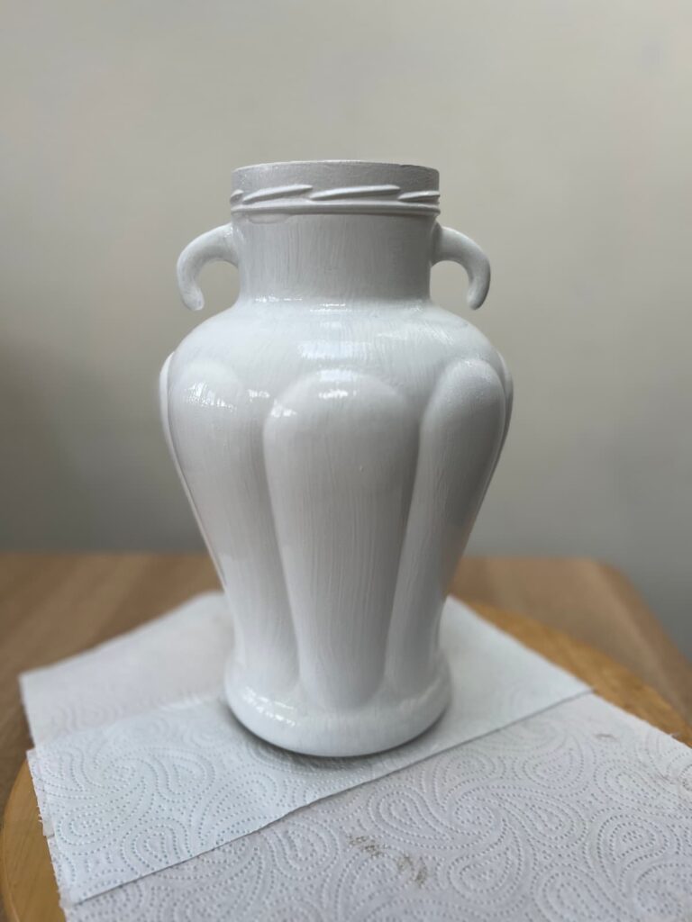 image shows two coats of slick stick on glass vase.