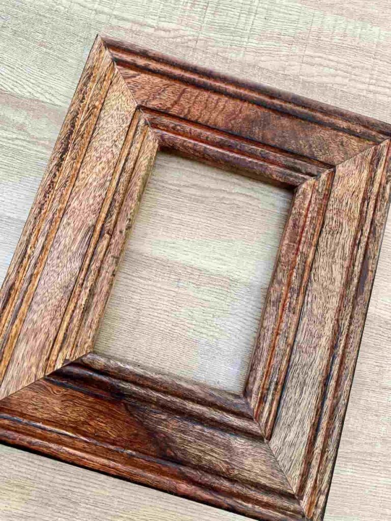 image shows wooden photo frame with repaired scratches.