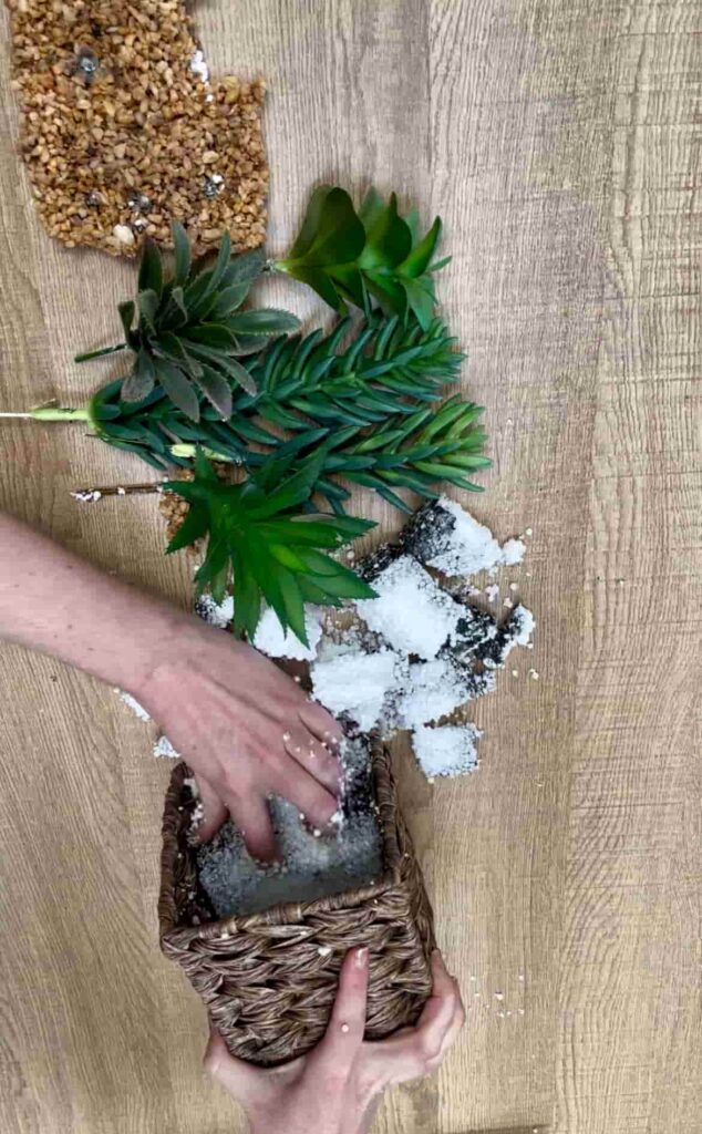 image shows removing polystyrene and faux plants from pot.