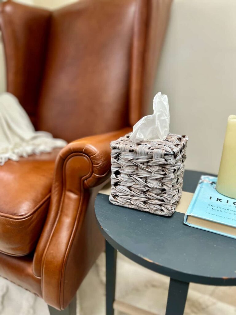 image shows tissue box on a table next to a chair.