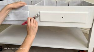 painting the edges of the drawers with an artist brush