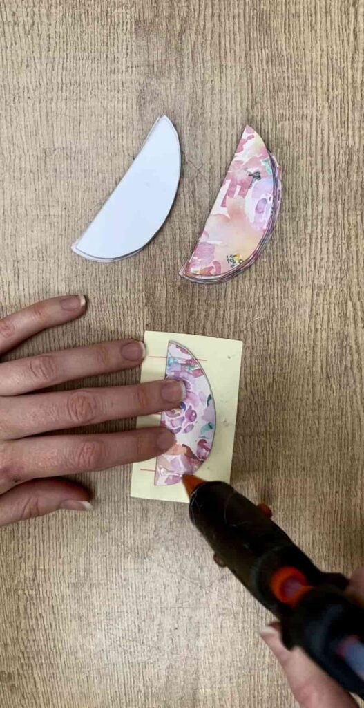 image shows gluing edges of paper easter egg.