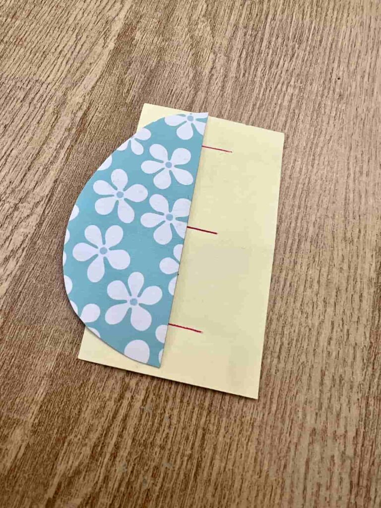 image shows guide for where to add glue and half easter egg shape made from paper.