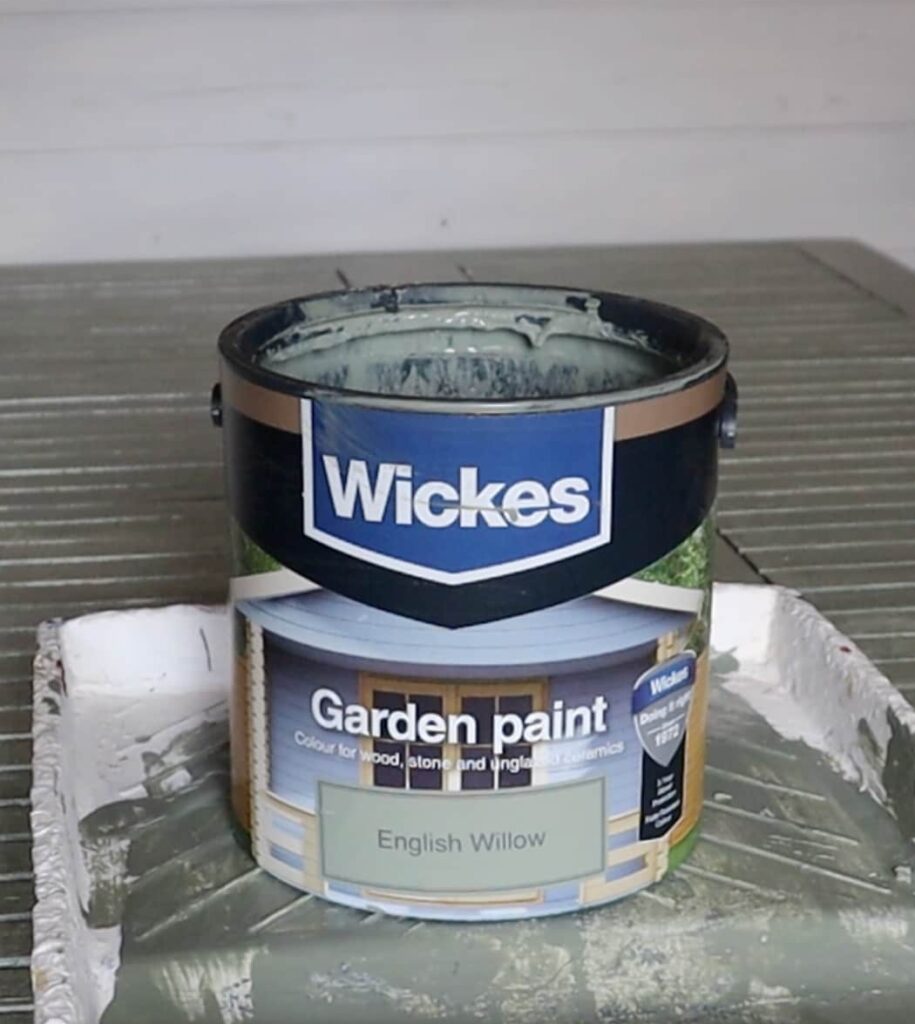 image shows paint can of green paint.