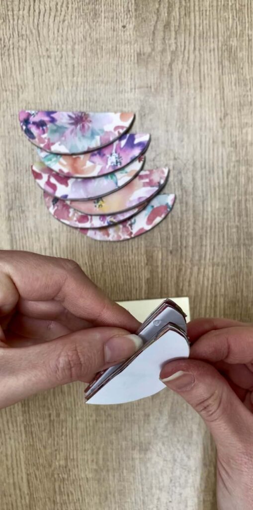 image shows attaching paper easter eggs shapes together with glue.